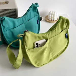 Detail view of casual canvas hobo shoulder bag with exterior pocket and adjustable strap.