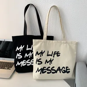 Large capacity canvas tote bag for women, casual student shoulder bag with letter print.
