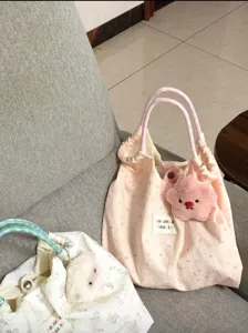 Cute canvas tote bag with cartoon rabbit print, large capacity casual commuter shoulder bag.