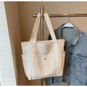 Large capacity canvas tote bag with front pocket, ideal for daily commuting, casual use.