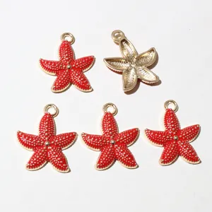 Closeup of red enamel starfish alloy pendants, showing front and back details for DIY jewelry.