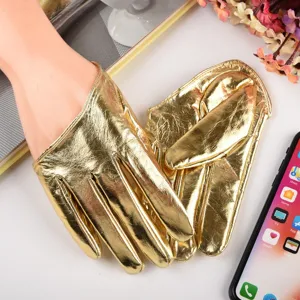 Close-up of shiny gold metallic full-finger PU gloves, stage performance accessory detail.