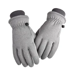 Detailed shot of grey thermal waterproof ski gloves with fleece lining and adjustable buckles.