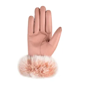 Close-up detail of women pink leather gloves with fluffy fur cuff for winter daily warmth.