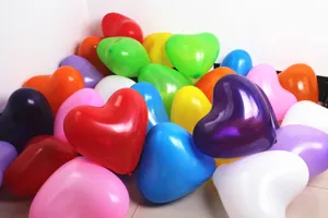 Colorful heart shaped latex balloons close up shot, perfect for wedding and party decor.