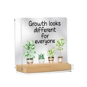 Plaque de bureau carrée en acrylique avec base en bois, citation inspirante et plantes.
