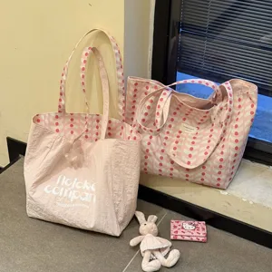 Close-up detail of the pink wave pattern canvas tote bag, showing fine fabric texture and print.