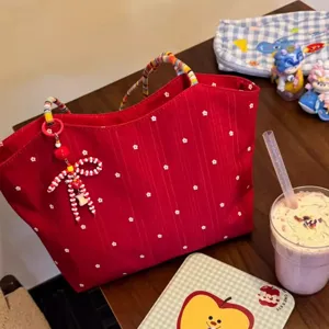 Korean style red floral canvas tote bag with colorful woven handles and beaded bow charm.