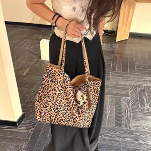 Leopard canvas tote bag for women, large capacity shoulder bag with stylish print and cute pendant.