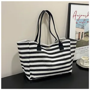 Black and white striped canvas tote bag, large capacity casual handbag for daily commute.