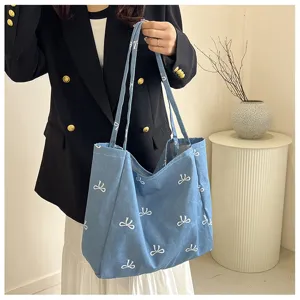 Blue denim tote bag featuring sweet white bow prints, spacious shoulder bag for women.