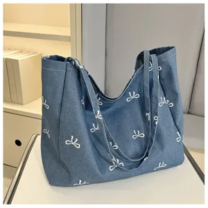 Casual denim tote bag for women with white bow print, large capacity canvas shoulder bag.