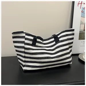 Classic black and white striped canvas tote bag detail, large capacity casual shoulder bag.