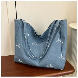 Blue denim tote bag for women, cute bow print casual shoulder handbag with large capacity.