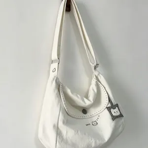 Large capacity white canvas shoulder bag with cute cat embroidery and plaid pendant for women.