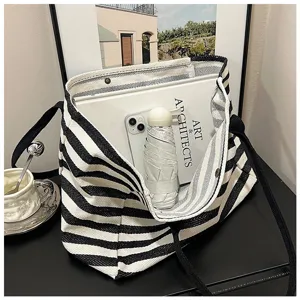 Classic black and white striped canvas tote bag, large capacity shoulder bag for daily commuting.