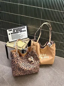 Detailed view of large capacity leopard print canvas tote bag, casual commuter shoulder bag.