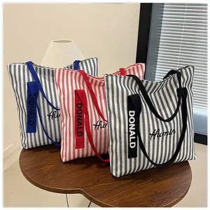 Striped canvas tote bag detail view, large capacity casual shoulder bag in multiple colors.