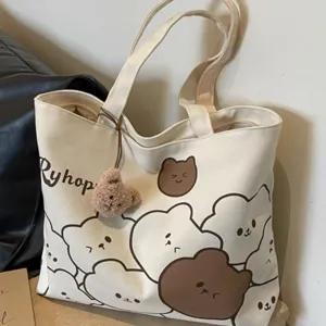 Casual canvas tote bag with cute cartoon bear print and pendant for students daily commuter.