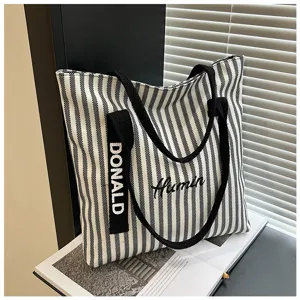 Black and white striped canvas tote bag, large capacity shoulder handbag for daily commuting.