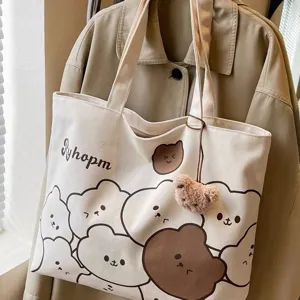 Detailed view of casual canvas tote bag with cute bear print and furry pendant accessory.