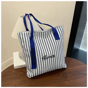 Blue white striped canvas tote bag large capacity casual shoulder bag for daily commuting use.