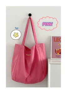 Detail view of pink canvas tote bag, featuring minimalist candy color design and stitching.