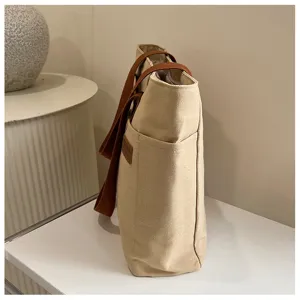 Sac cabas en toile détail latéral, sac à main pour commuteur étudiant minimaliste et décontracté.