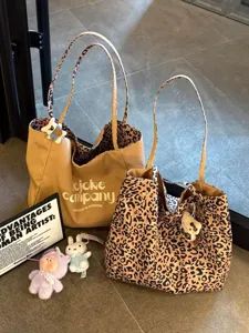 Detailed view of large capacity leopard print and solid canvas tote bags for daily commute.