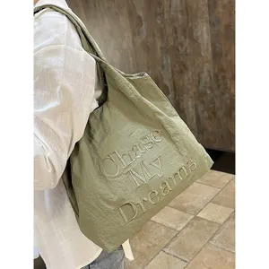 Casual green nylon tote bag with embroidered letter design, lightweight and spacious.