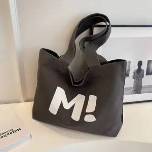 Minimalist dark grey canvas tote bag with bold white letter M print, casual shoulder bag for women