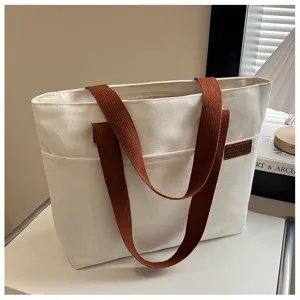 Minimalist canvas tote bag for women, large capacity casual shoulder bag with brown straps.