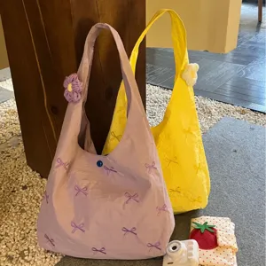 Large capacity canvas tote bag with cute embroidery bows and knit flower for daily commuting.
