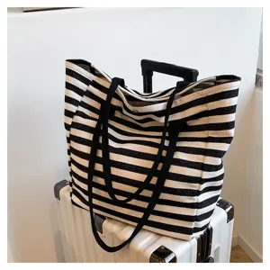 Detail view of black white striped canvas tote bag detail view large capacity commuter handbag