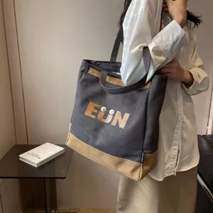 Casual canvas tote bag for women, large capacity shoulder bag for daily commute and school use.