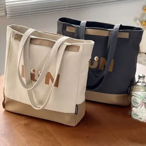 Casual canvas tote bag for women, large capacity shoulder bag for daily commute and school.
