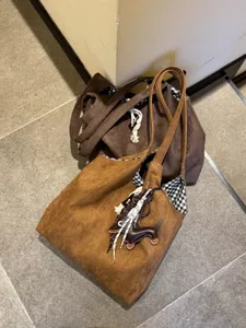 Brown suede tote bag set with cute dachshund charm and classic check lining for autumn.