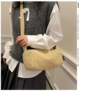 Detail view of the stylish corduroy cylinder shoulder bag with durable strap and large capacity.