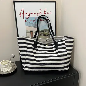 Black and white striped canvas tote bag, large capacity casual shoulder bag for daily commute.