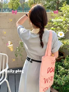 Casual pink canvas tote bag with stylish letter print, large capacity for daily commute and school.
