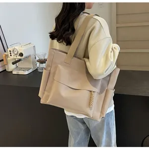Detailed view of large capacity canvas tote bag, casual commuter shoulder bag in beige.