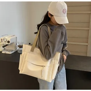 Detailed view of the stylish vintage canvas tote bag showcasing large capacity and pockets.