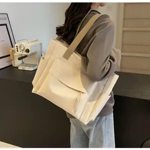 Large capacity canvas tote bag for women, stylish casual shoulder bag with wide strap for daily commute.