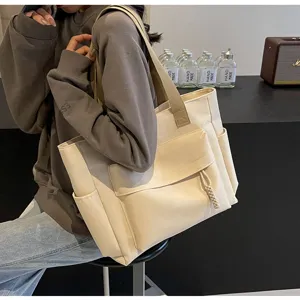 Detail shot of stylish canvas tote bag with large capacity, casual shoulder bag for women.