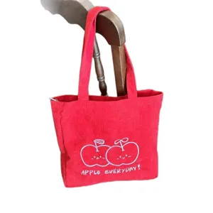 Red corduroy tote bag with cute apple embroidery and everyday lettering. Casual shoulder bag.