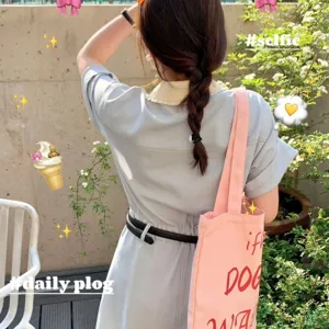 Pink canvas shoulder bag with red letter print, large capacity tote bag for daily commute.