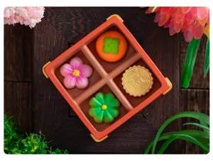 Miniature wagashi pastry resin DIY ornament detail view on wood texture background.
