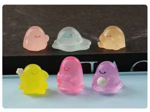Close-up detail of colorful glowing mini resin figurines, cute desktop landscape decor items.