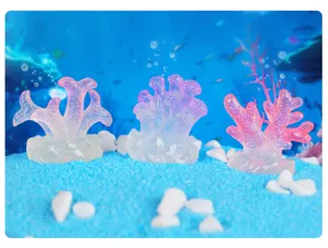 Detailed view of glowing resin coral ornaments for aquarium decoration, miniature fish tank scape.