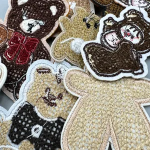 Close-up of cute cartoon bear embroidery patches, towel embroidery details for kids clothing.